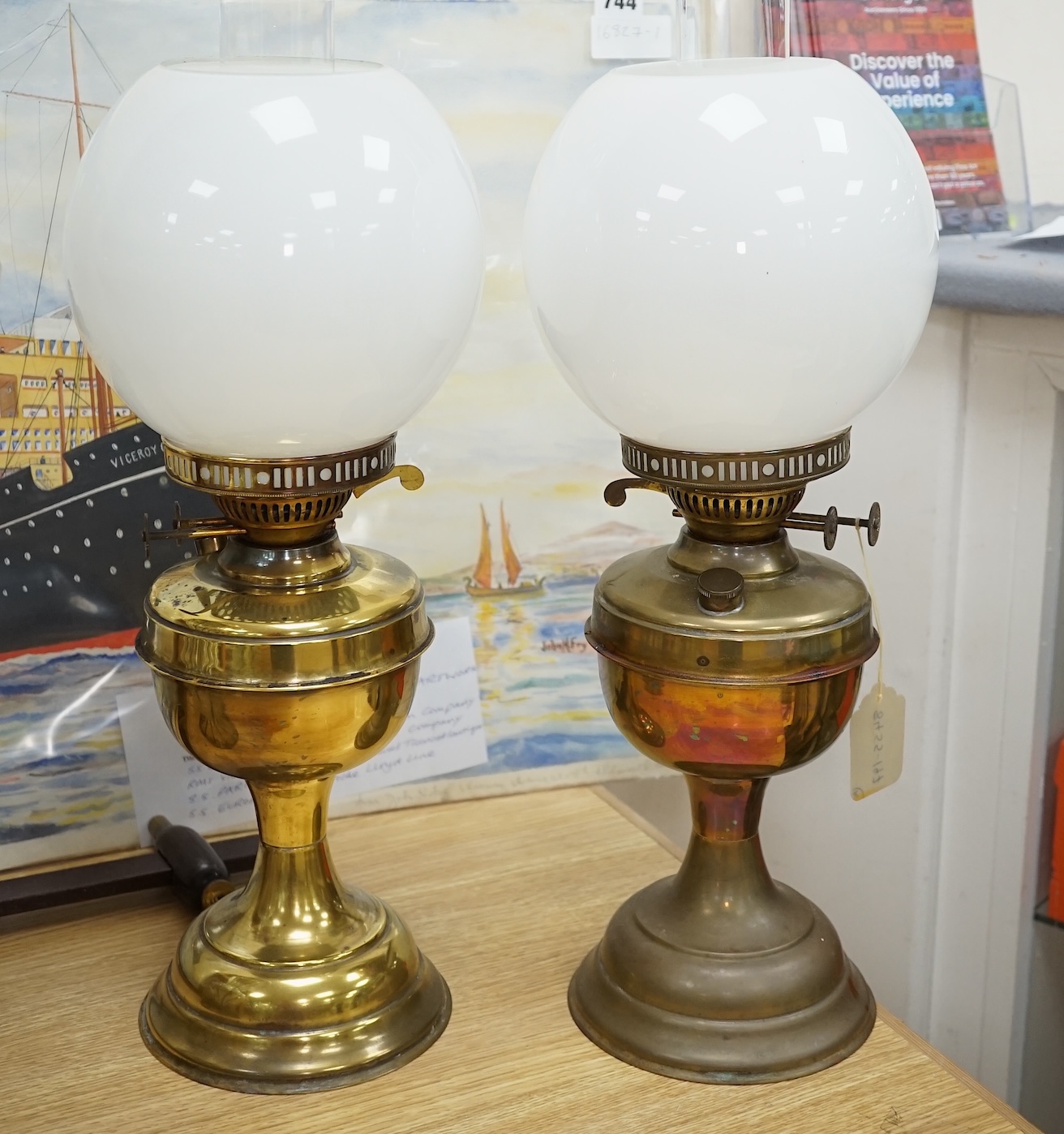 Two Victorian brass oil lamps with white glass shades, 50cm high including funnel. Condition - one tarnished